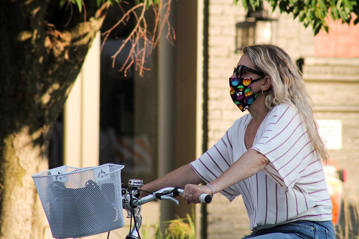 girl on bike with mask