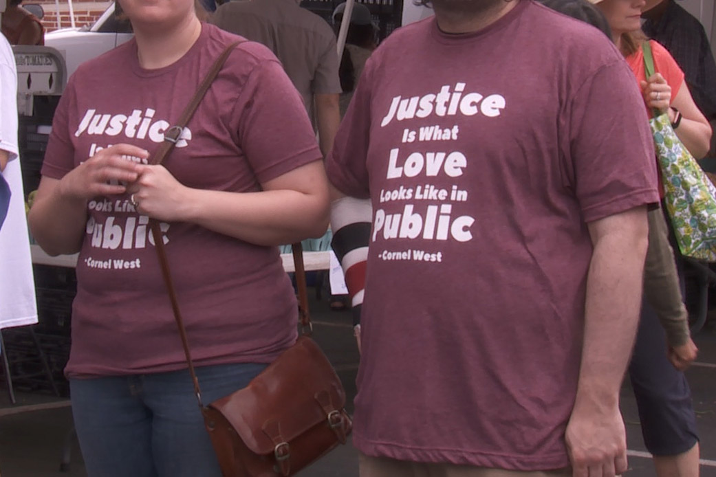 Protestors in front of the Schooner Creek Farm stand at the Bloomington Farmers' market. Sept. 21, 2019.