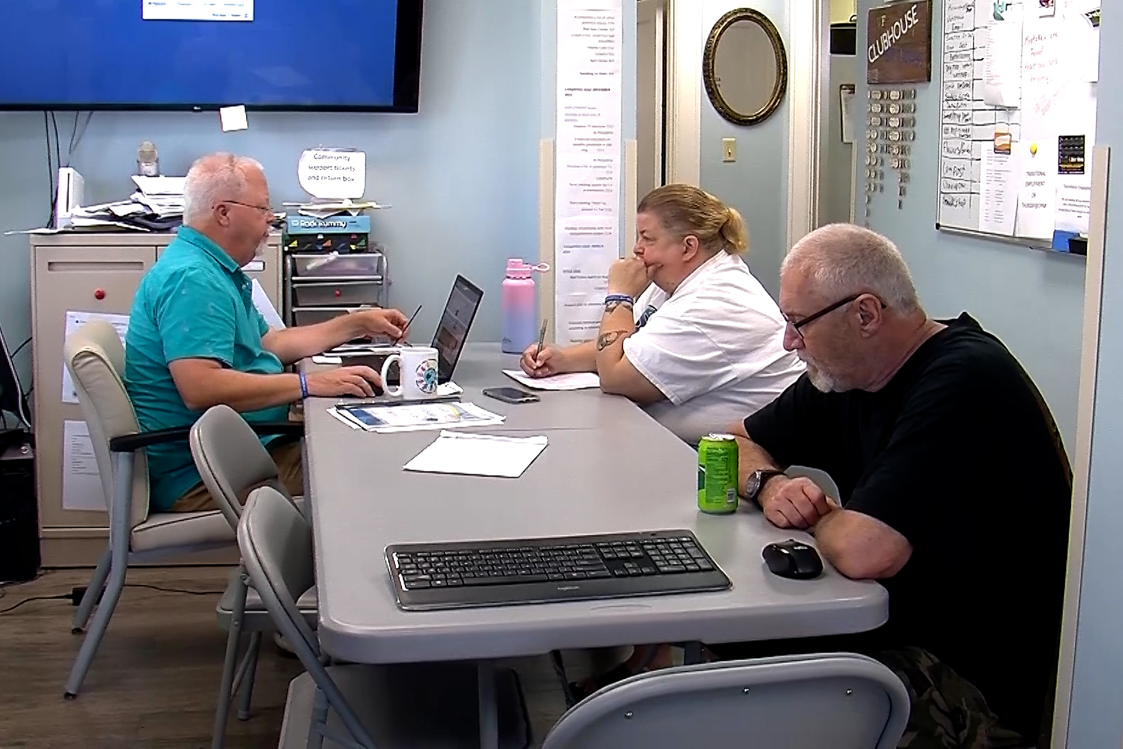 Dave Engstrom, left, works with members of the Wabash Valley Friendship Clubhouse