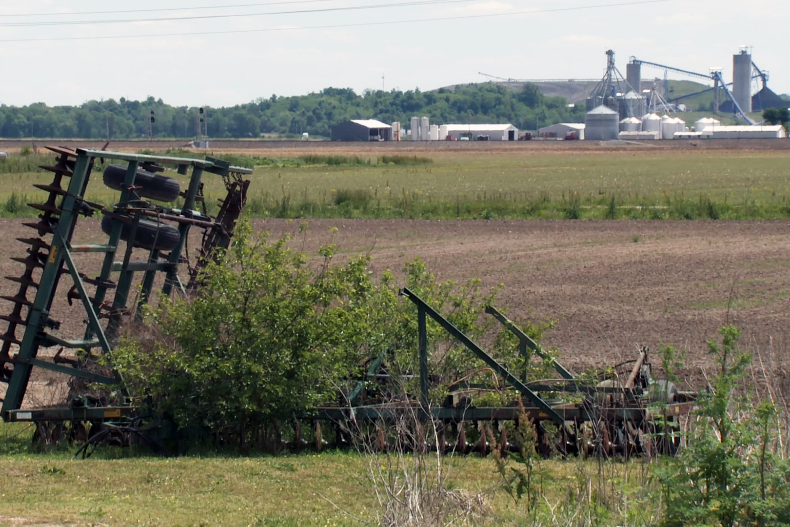 a farm with larger farm in background