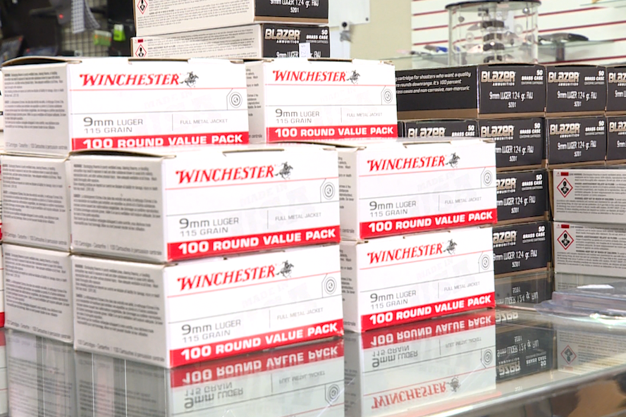 A box of gun ammo sitting on top of a display case. 