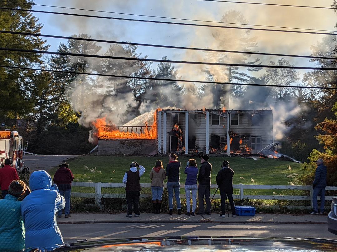 residents watch a controlled burn of a house on South High Street last Friday.