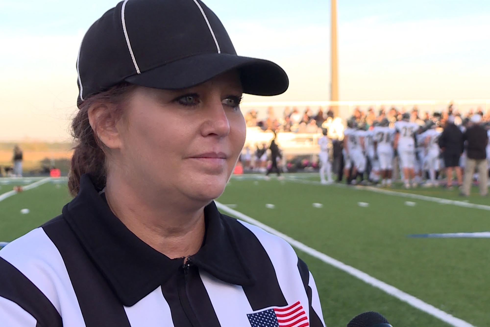 Holly McCammack is one of about a dozen licensed football officials, and usually is on the field officiating with her husband.