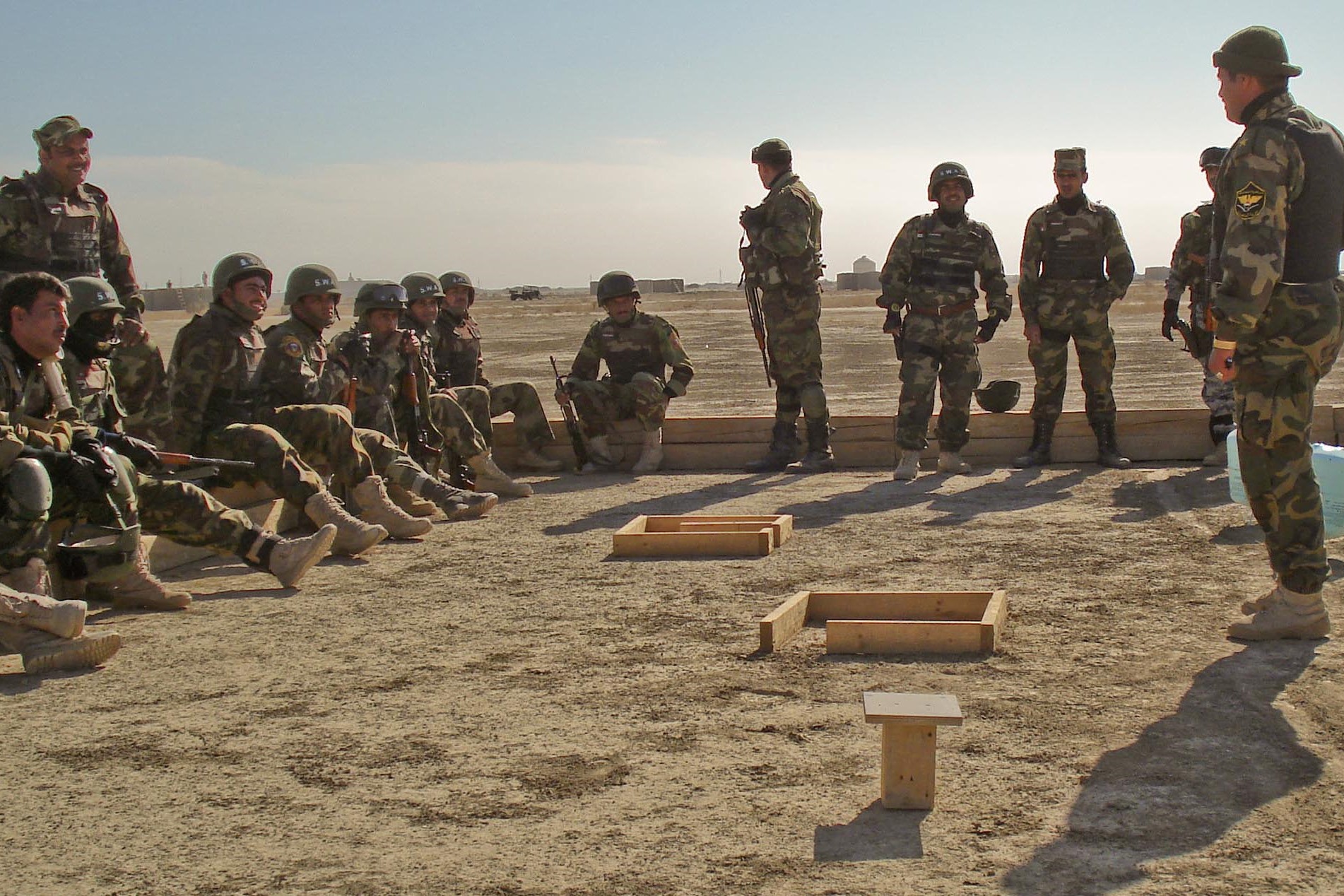 Iraqi policeman Lt. Ahmed, center, and members of his special weapons and tactics team look on during training at Convoy Support Center Cedar in Iraq’s Dhi Qar province in December 2008.