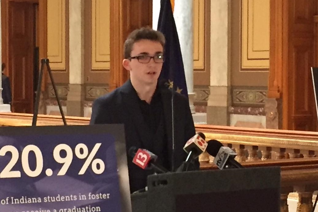 Former foster youth Joshua Christian speaks at a podium at an event at the Indiana Statehouse.