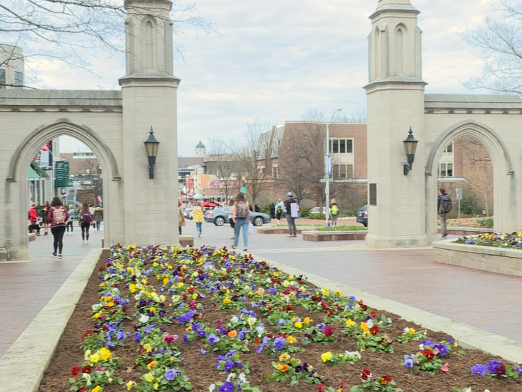 Students walking through the Sample Gates