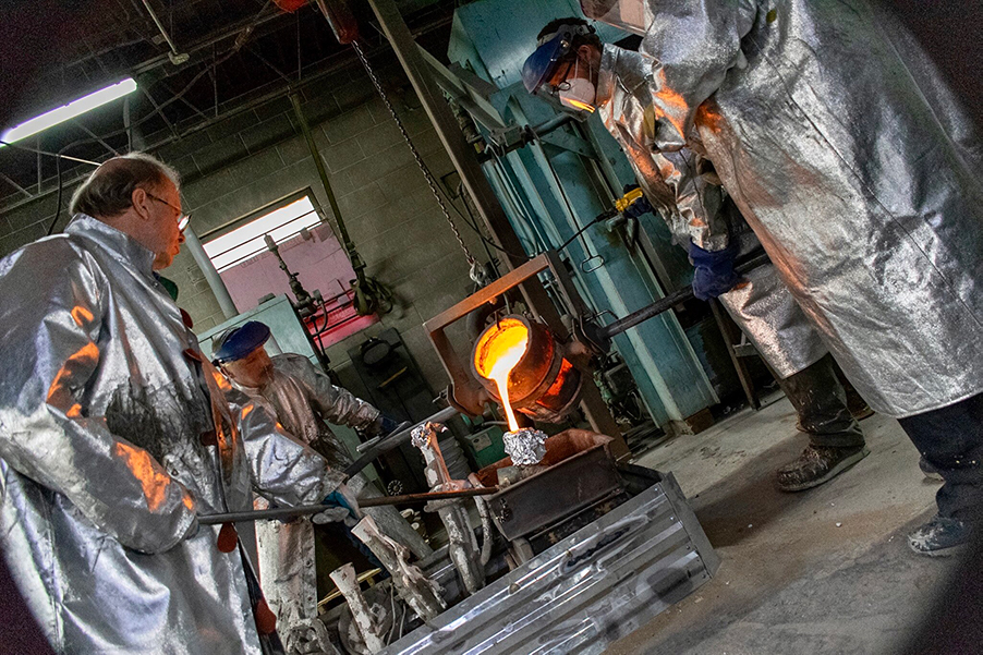 Pouring bronze over the cast of the Captain Janeway sculpture