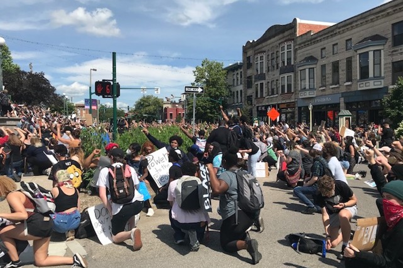 People Kneeling In Dowtown