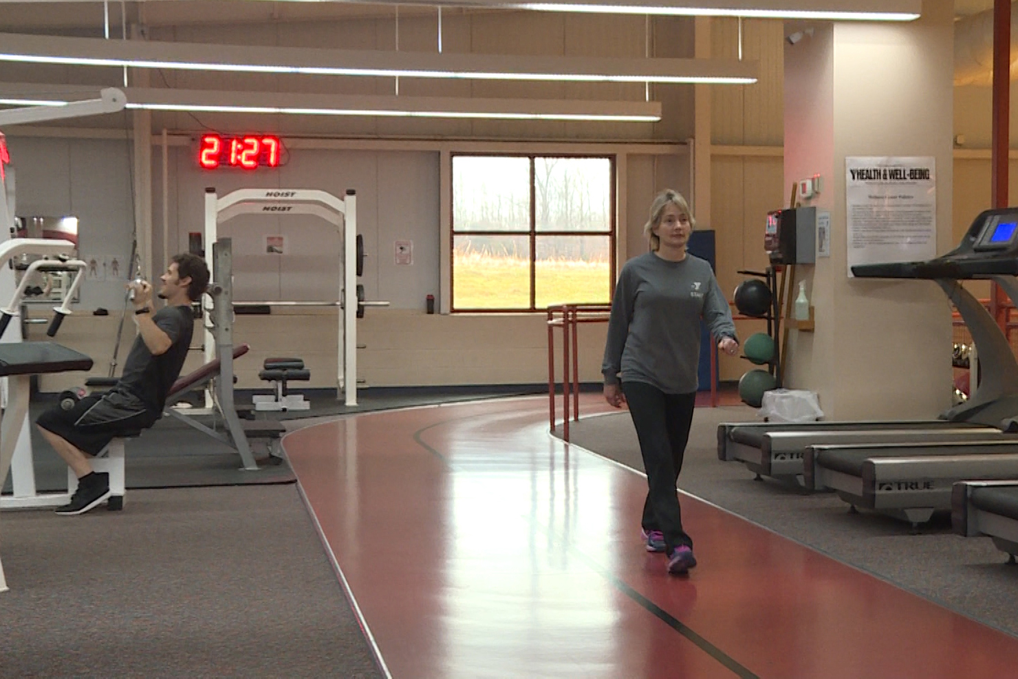 woman walking on indoor track