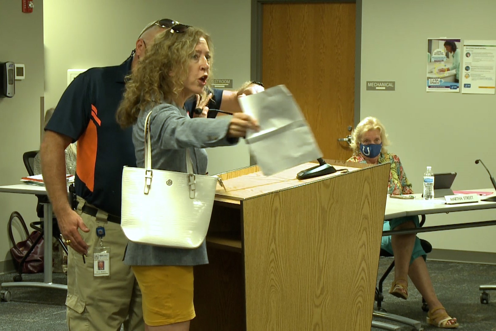 Resident Margaret Menge refusing to wear a school inside an MCCSC Board of Trustees meeting.