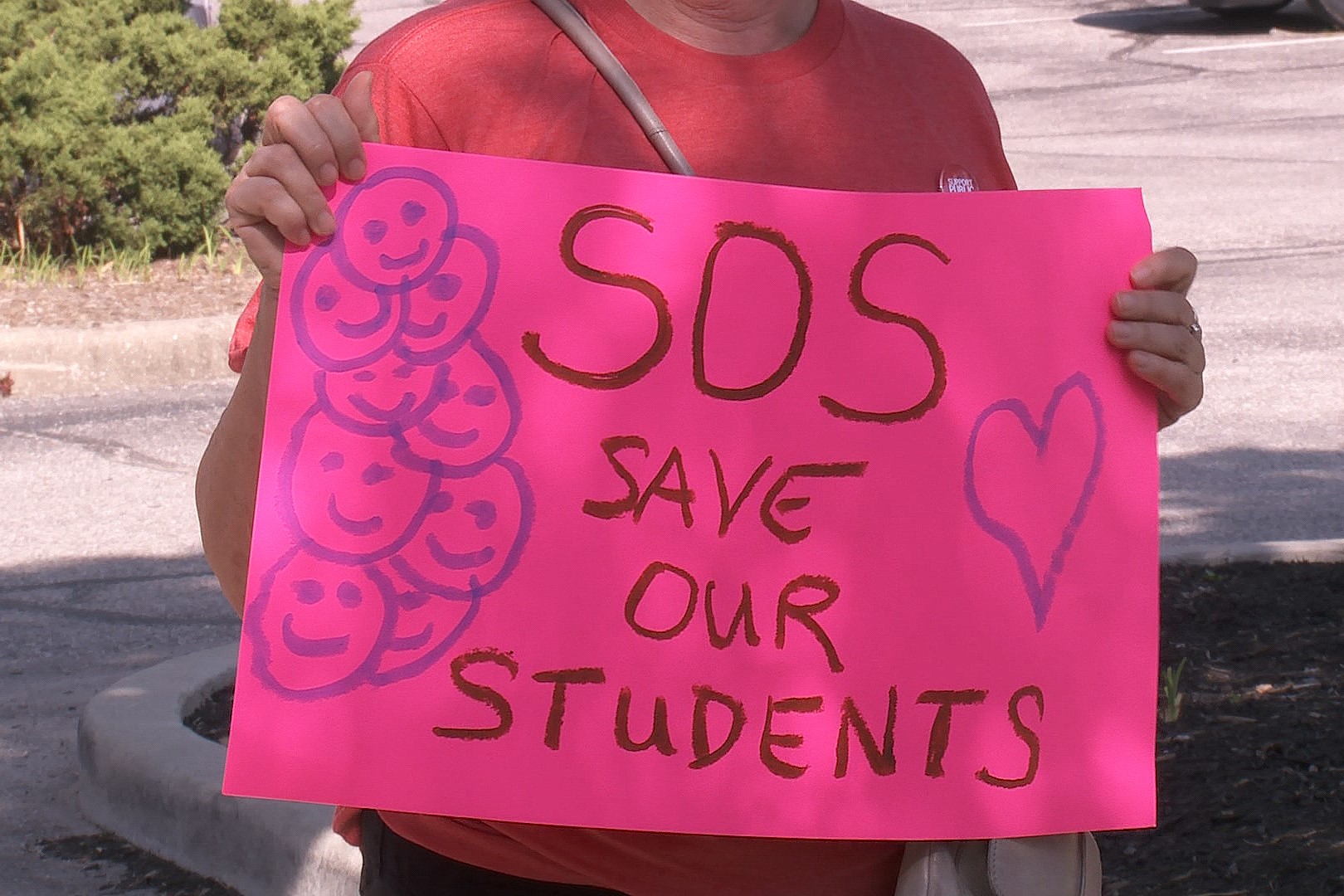 A sign that says "Save Our Students."