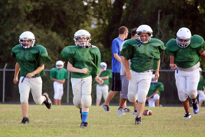 Kids at a middle school football practice (generic).