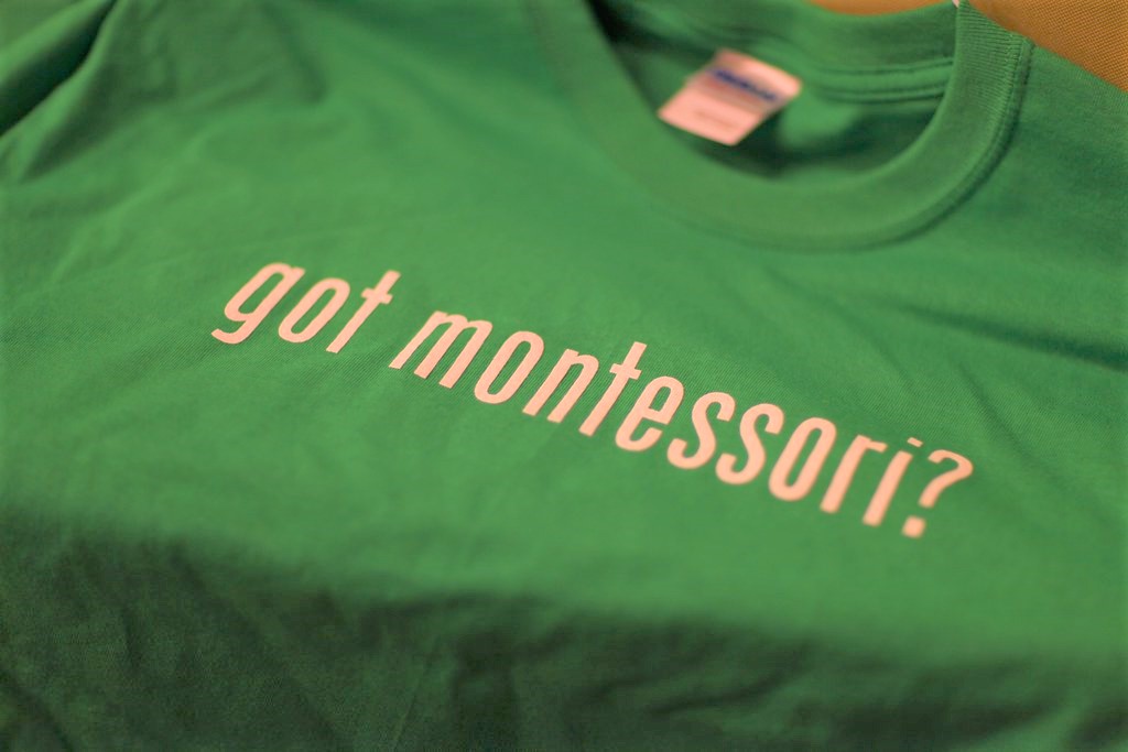 A green Montessori t-shirt.