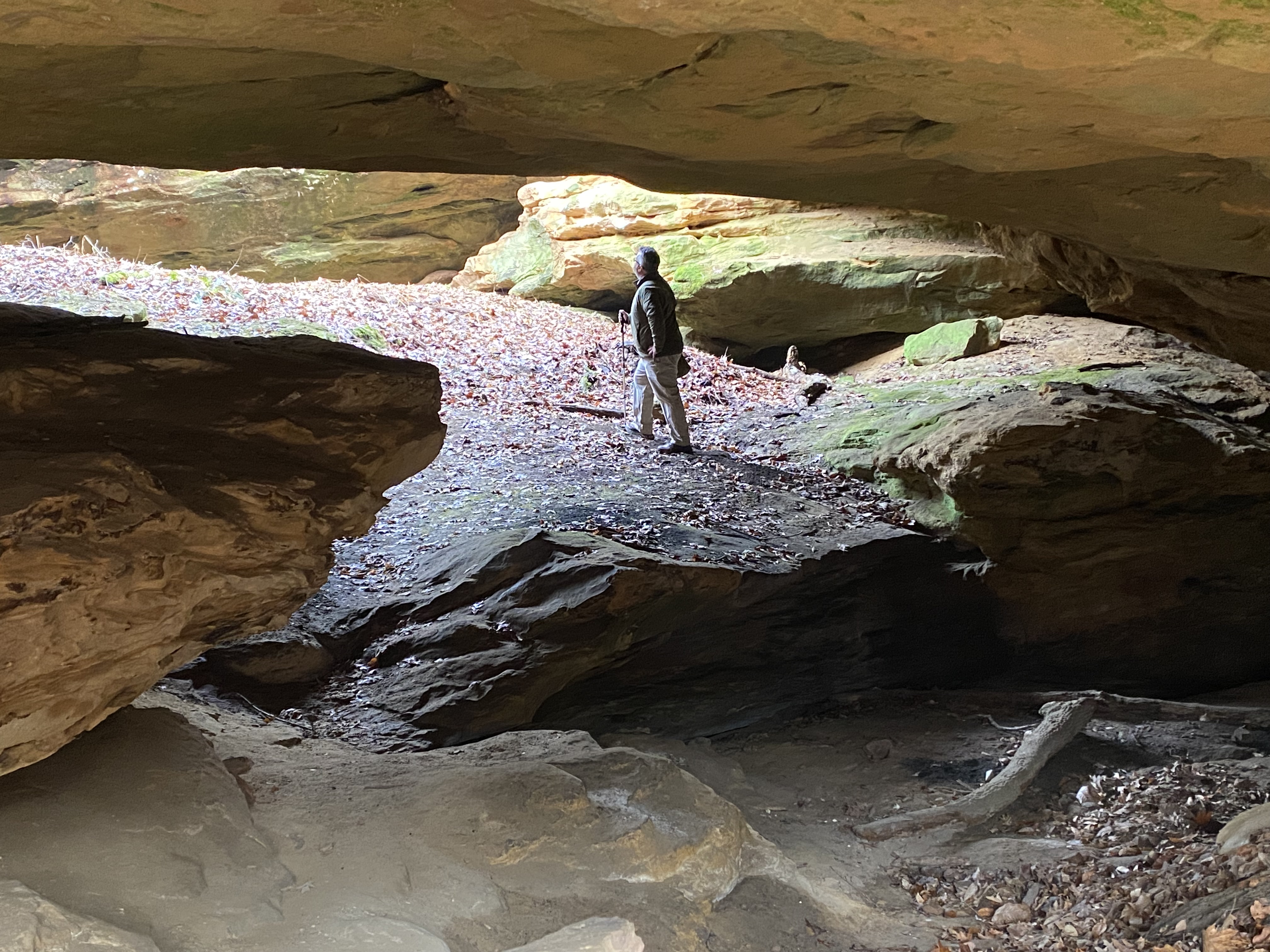 Cliff Chapman, president of the Central Indiana Land Trust, explores the Lowe tract sandstone arch.