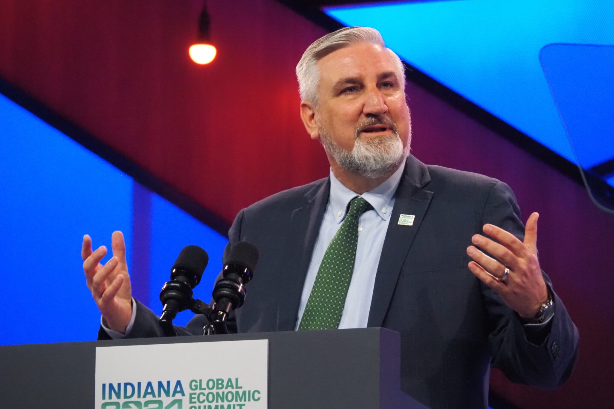 Gov. Eric Holcomb speaking at a podium