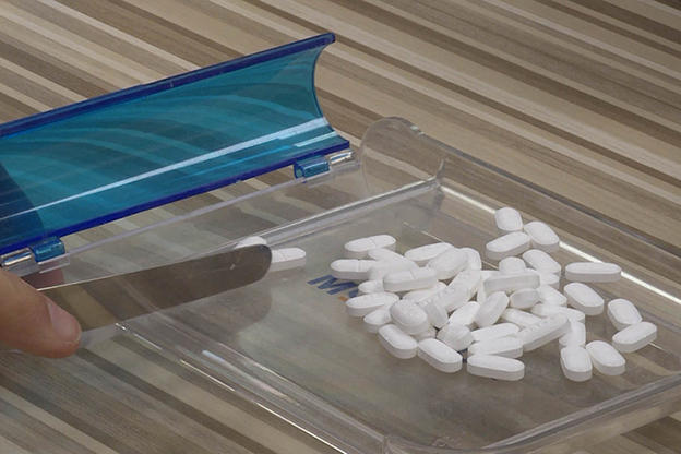 Pills in a container on a table.