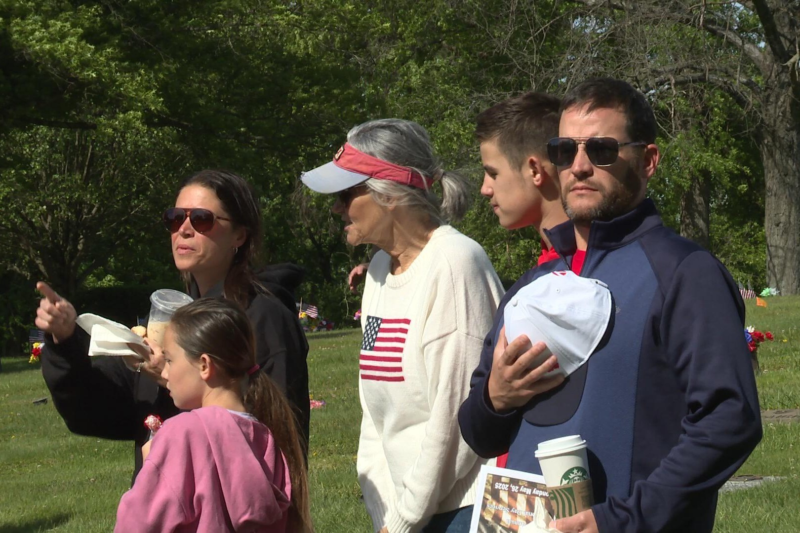 Valarie Gillaspy and her family stand for the Pledge of Allegiance during the Memorial Day ceremony at Valhalla Cemetery.