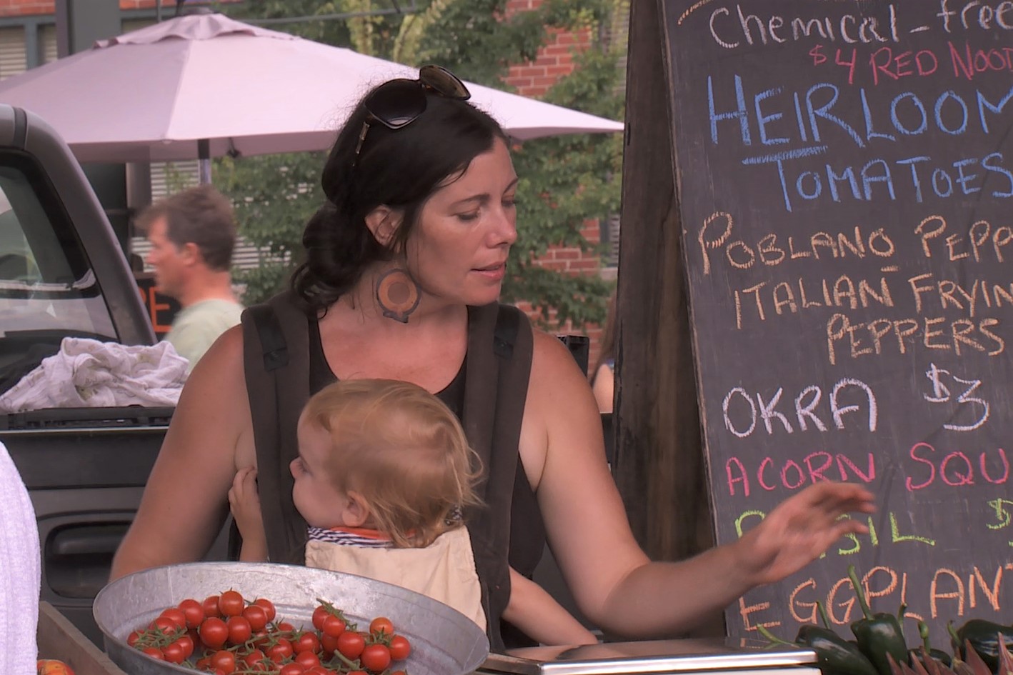 Sarah Dye interacts with customers at the Bloomington Community Farmers' Market, Aug. 17 2019.