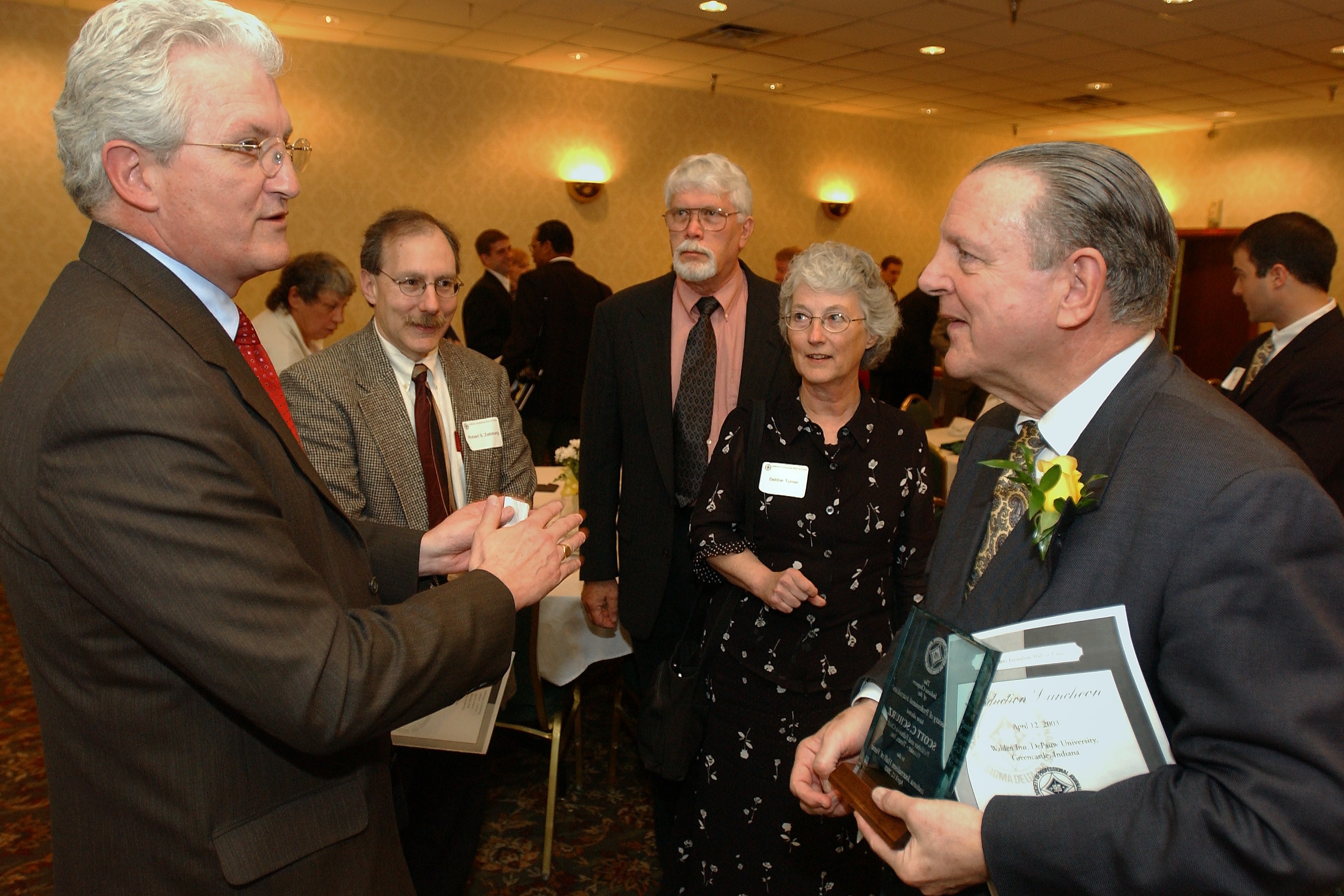 Scott Schurz (far right) is congratulated by incoming HT editor Mayer Maloney after being inducted into the Indiana Journalism Hall of Fame, April 2003.