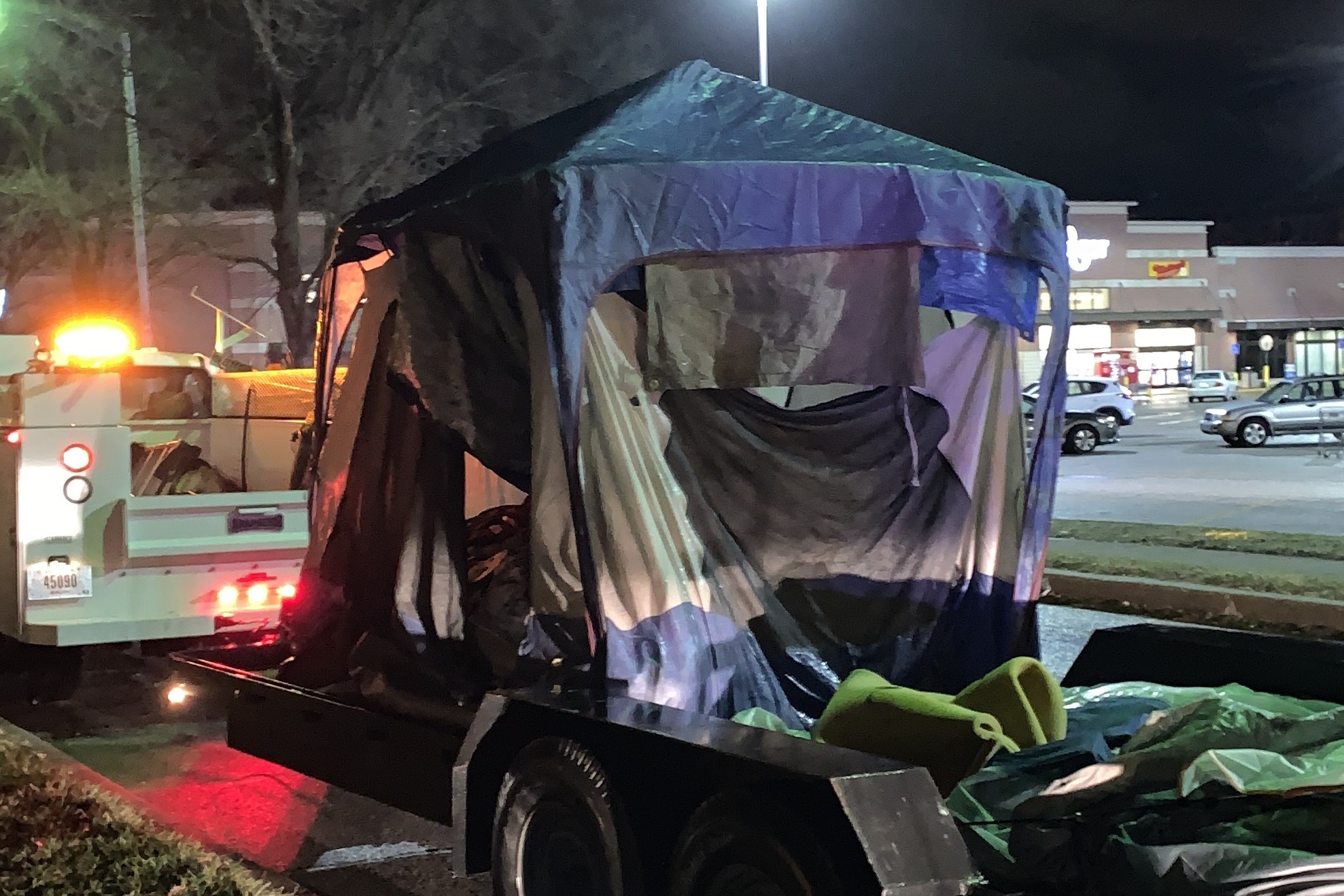 A tent from Seminary Park is put on a truck to be shipped out.