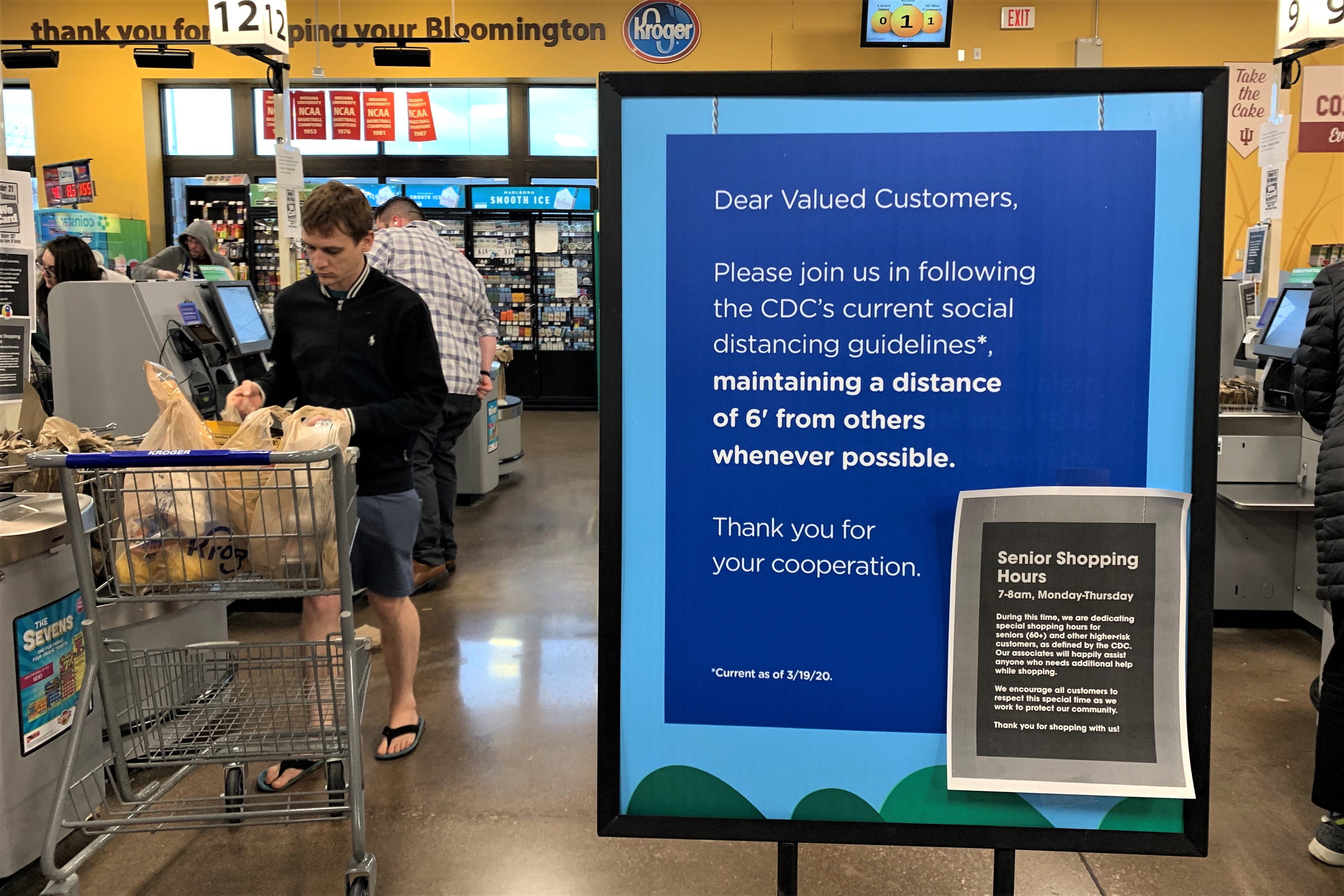 A sign inside Kroger educating customers about CDC-recommended social distancing guidelines.