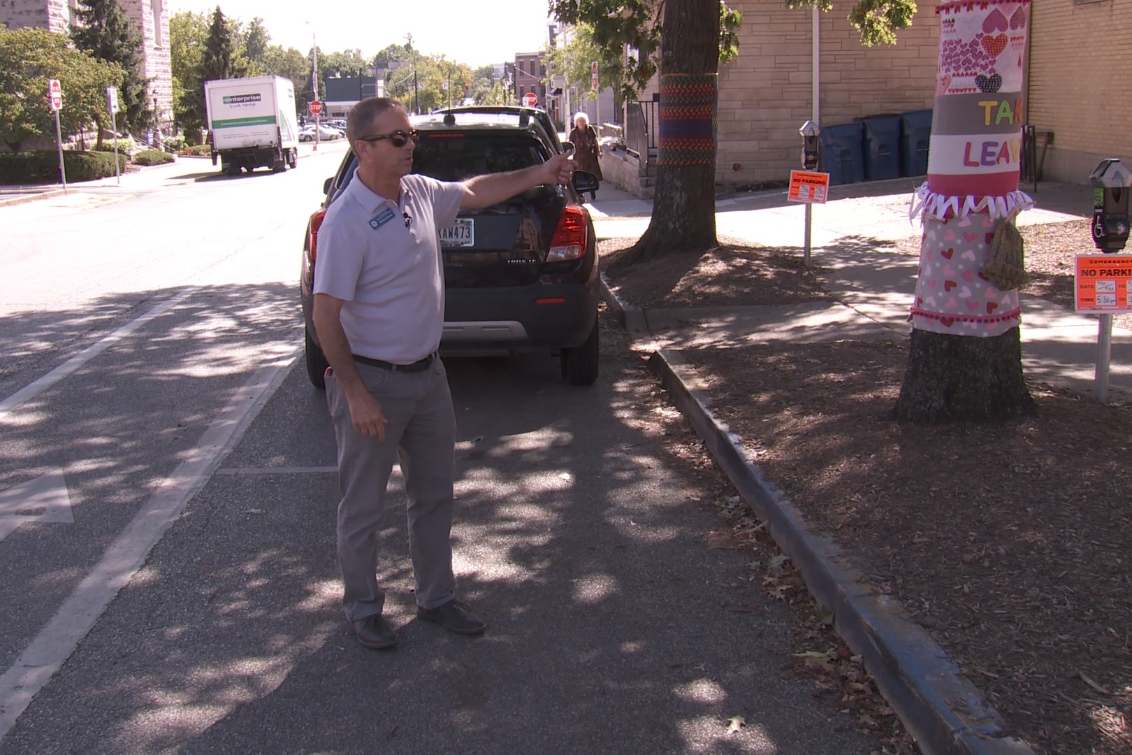 Man showing parking spot marked as wheelchair accessible.