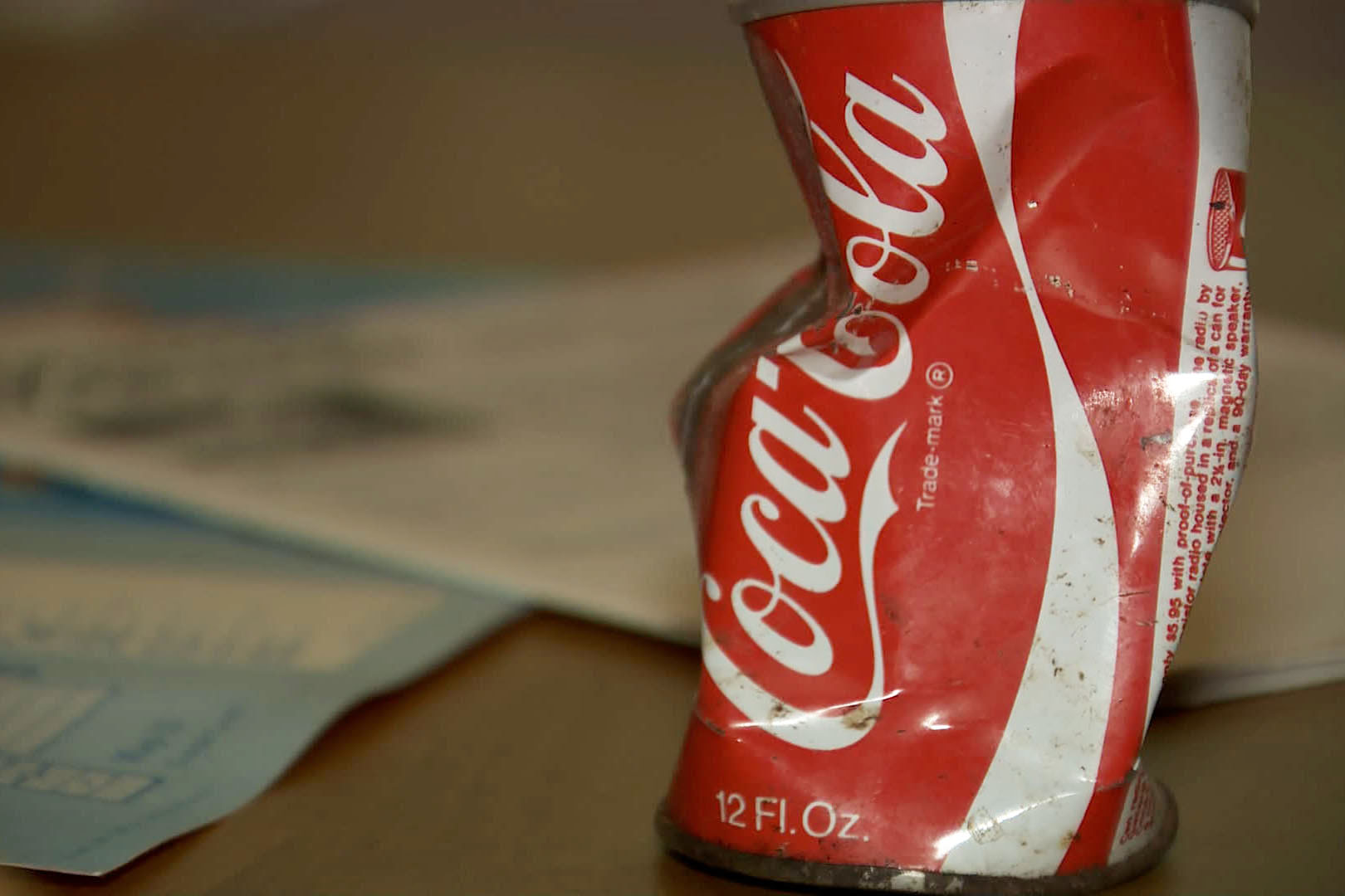 Eighties coke can crushed by Eleven