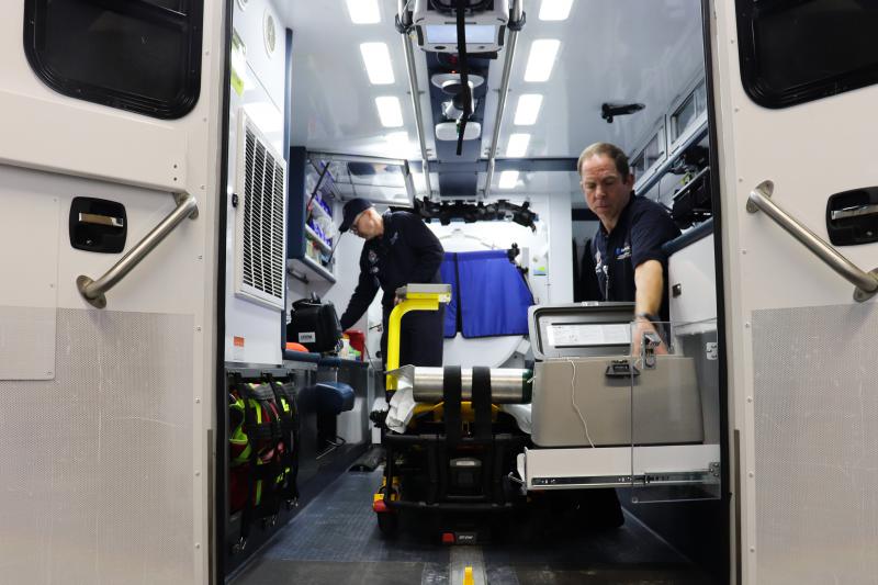 Paramedics Scott Widener (left) and Mike Warnimont (right) prepare the mobile stroke unit for the day.