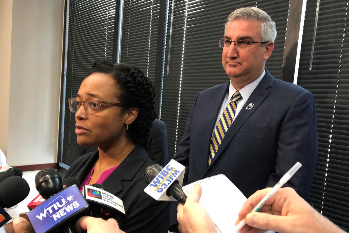 DCS Director Terry Stigdon and Gov. Eric Holcomb talk with the media after the release of an independent report on the agency in June 2018. 