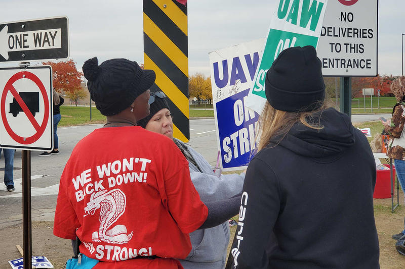UAW Local 2209 members autograph each others picket signs