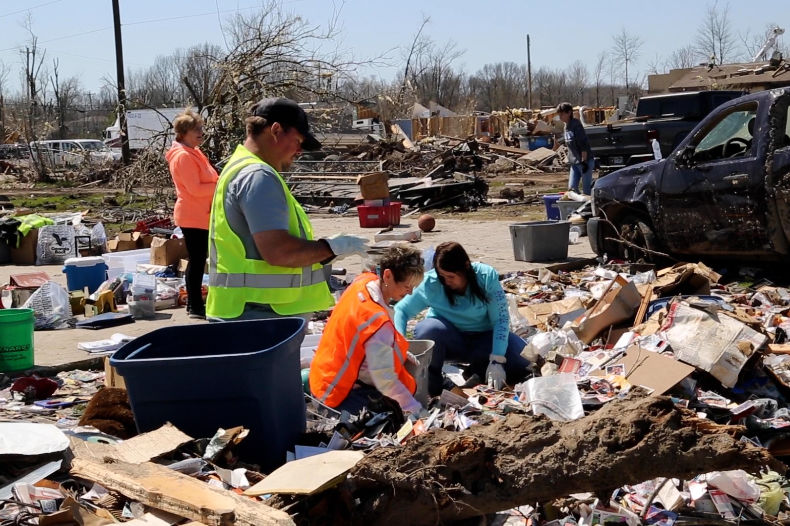 volunteers going through tornado debris
