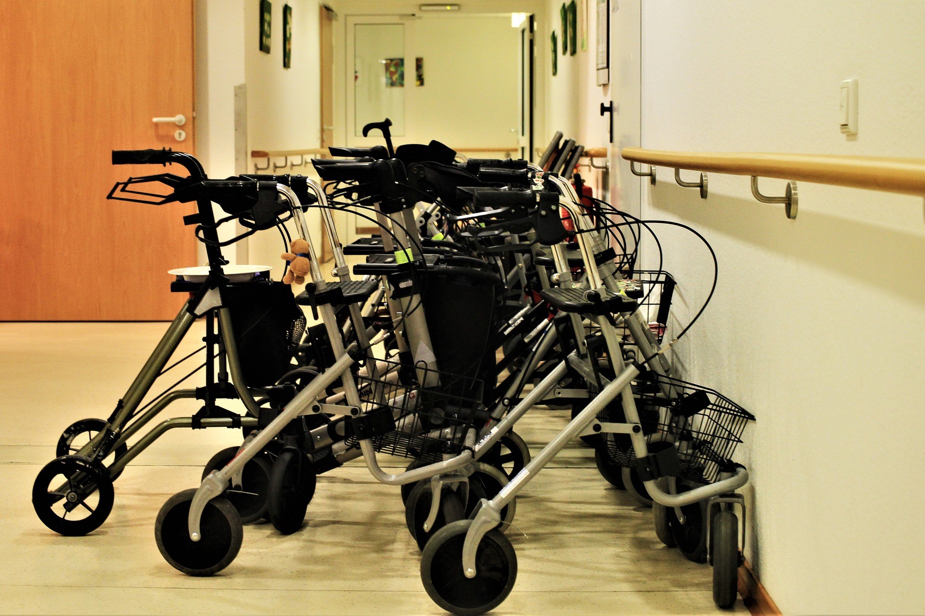 A stock photo of a line of walkers in a healthcare facility.