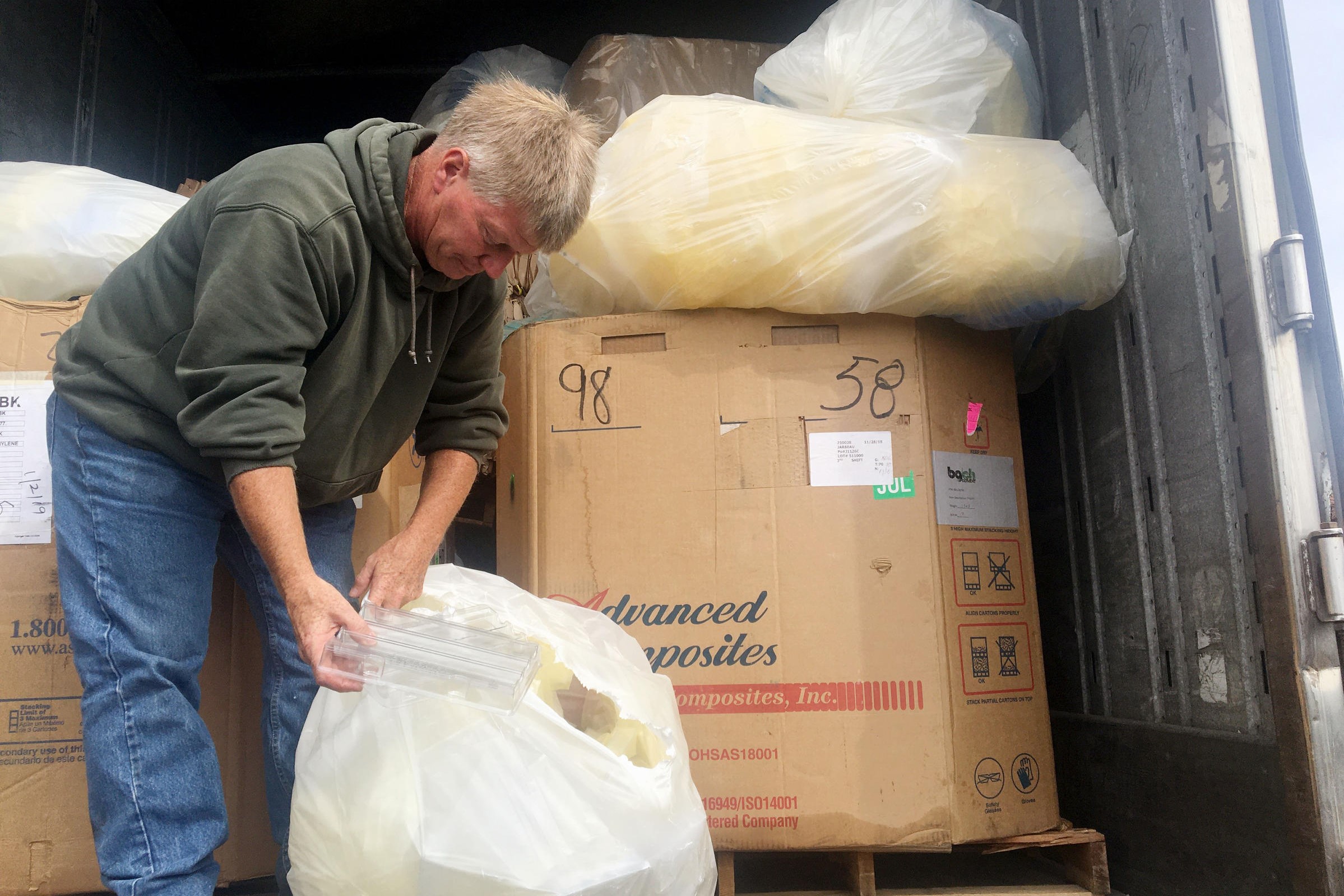 Troy Werner looks through a bag of industrial co-mingle, checking the contents for any contamination.