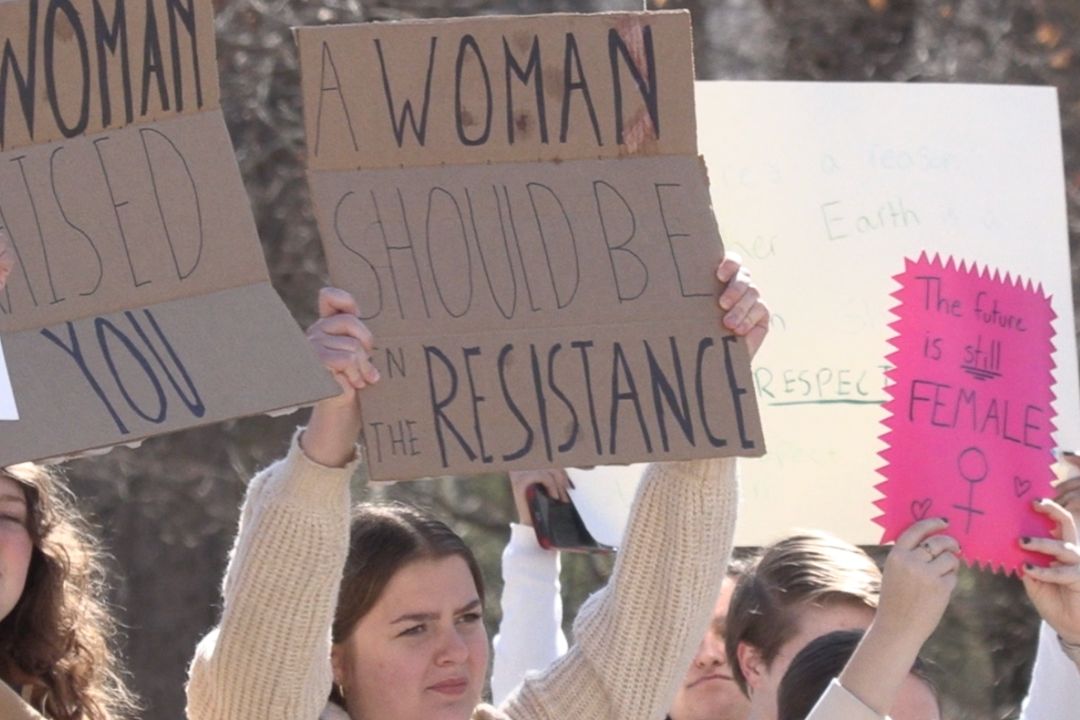 Anna Schweitzer holds her sign for the women's march.