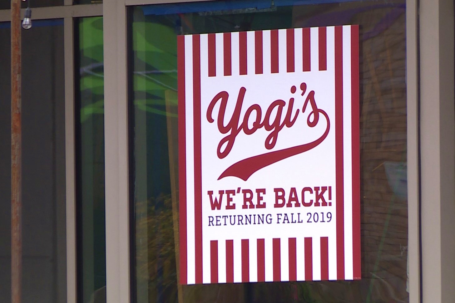A "we're back!" sign for Yogi's restaurant in downtown Bloomington. October 2019