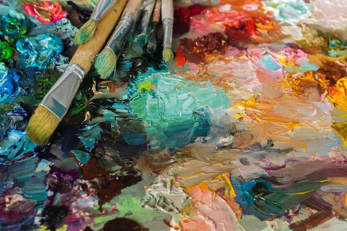 artist's palette with oil paints and brushes used for painting