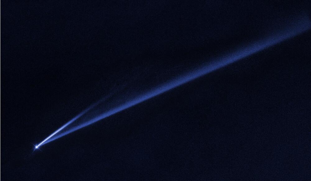 An asteroid streaking across the sky, falling apart in space