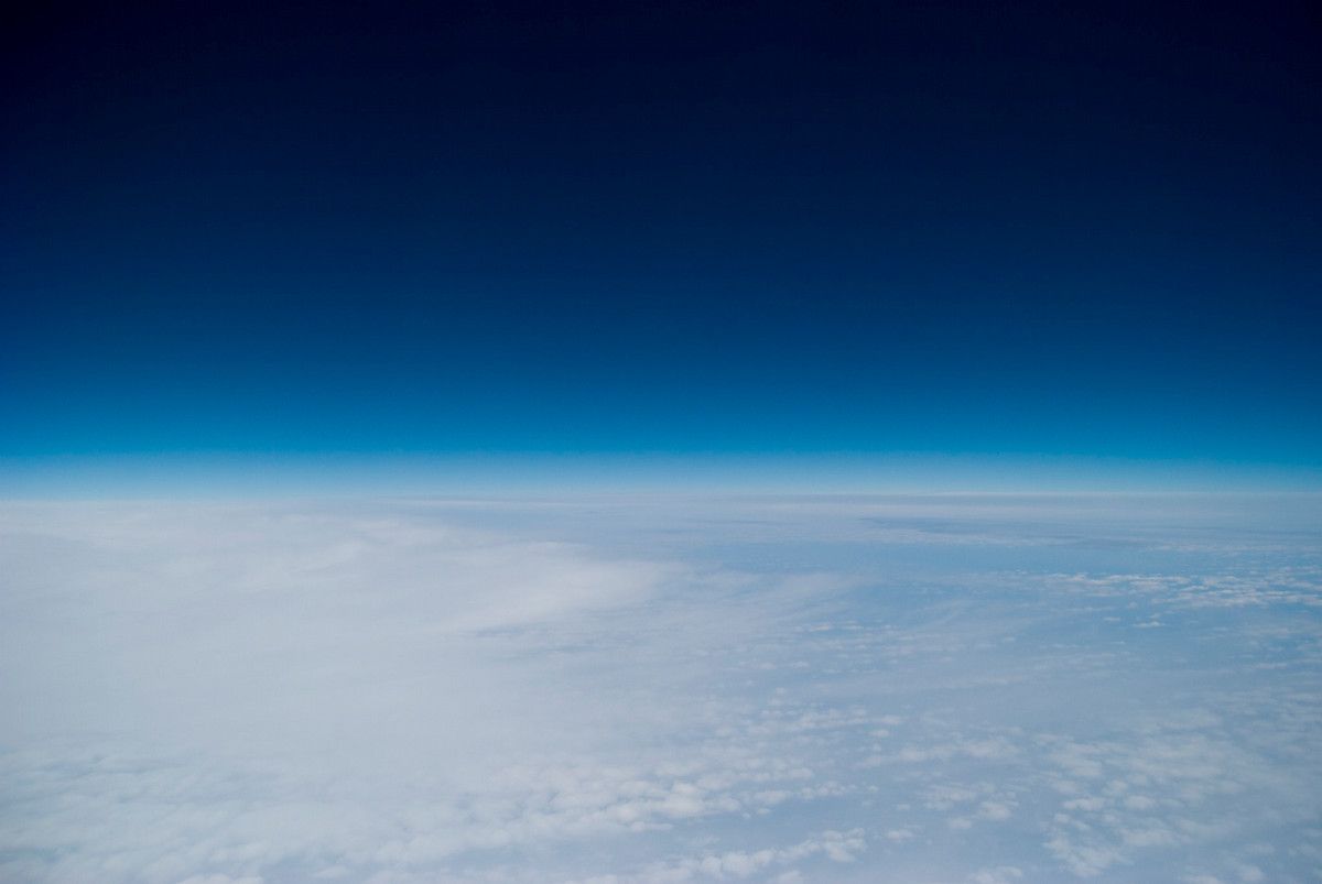 The hazy edge of Earth's atmosphere high above the clouds 