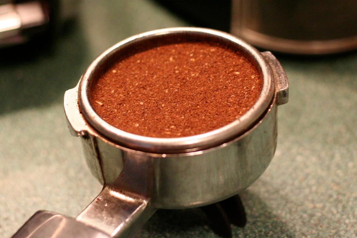 A tamped espresso shot full of grounds before being brewed