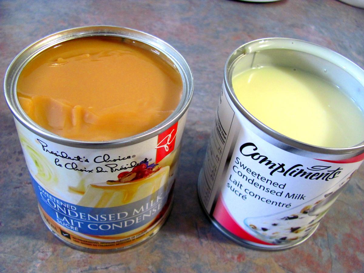 Two open cans of condensed milk, one a darker brown consistency on the left
