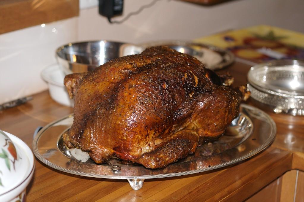 A well-seasoned cooked turkey on a silver platter