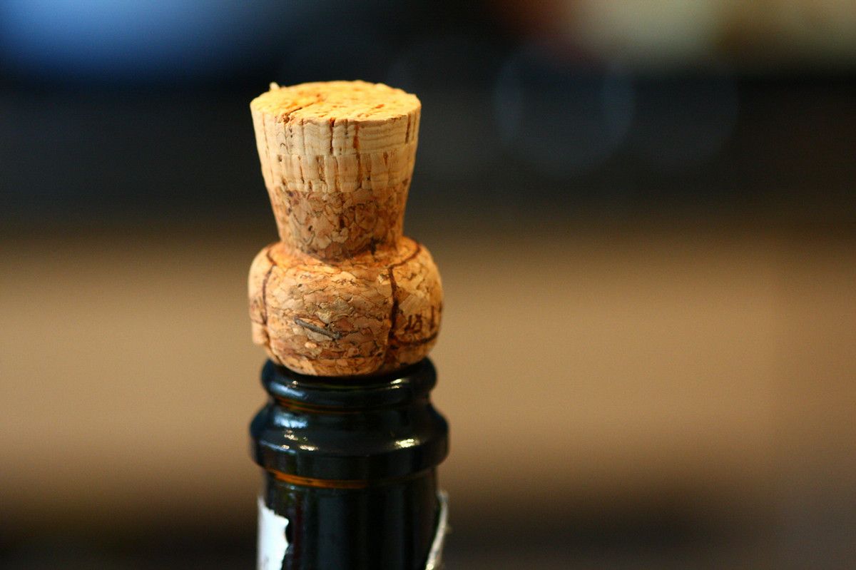 A cork resting on top of a wine bottle