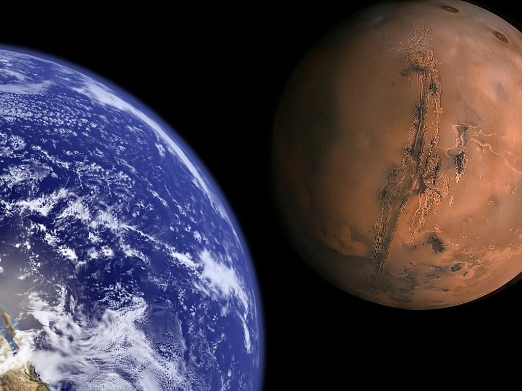 The Earth and Mars to scale shown next to each other on a black background