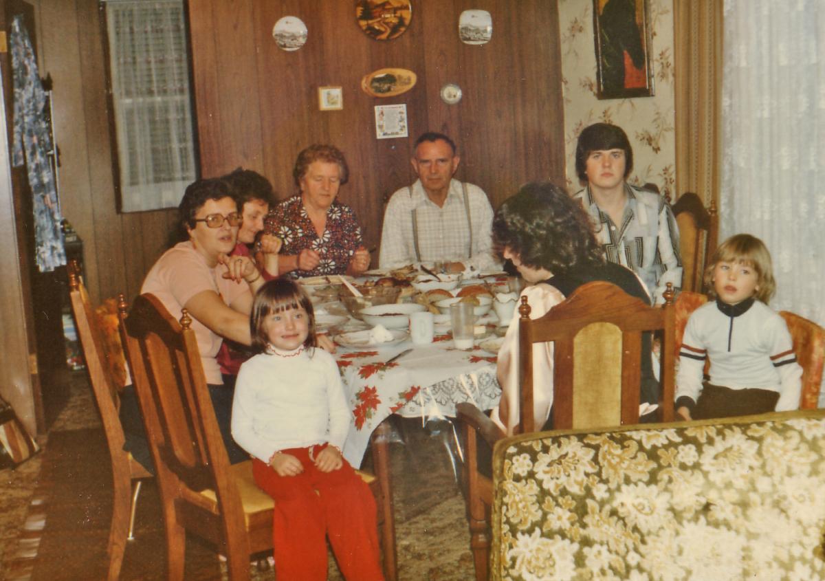 A family sits down to dinner sometime in the late 70s early 80s
