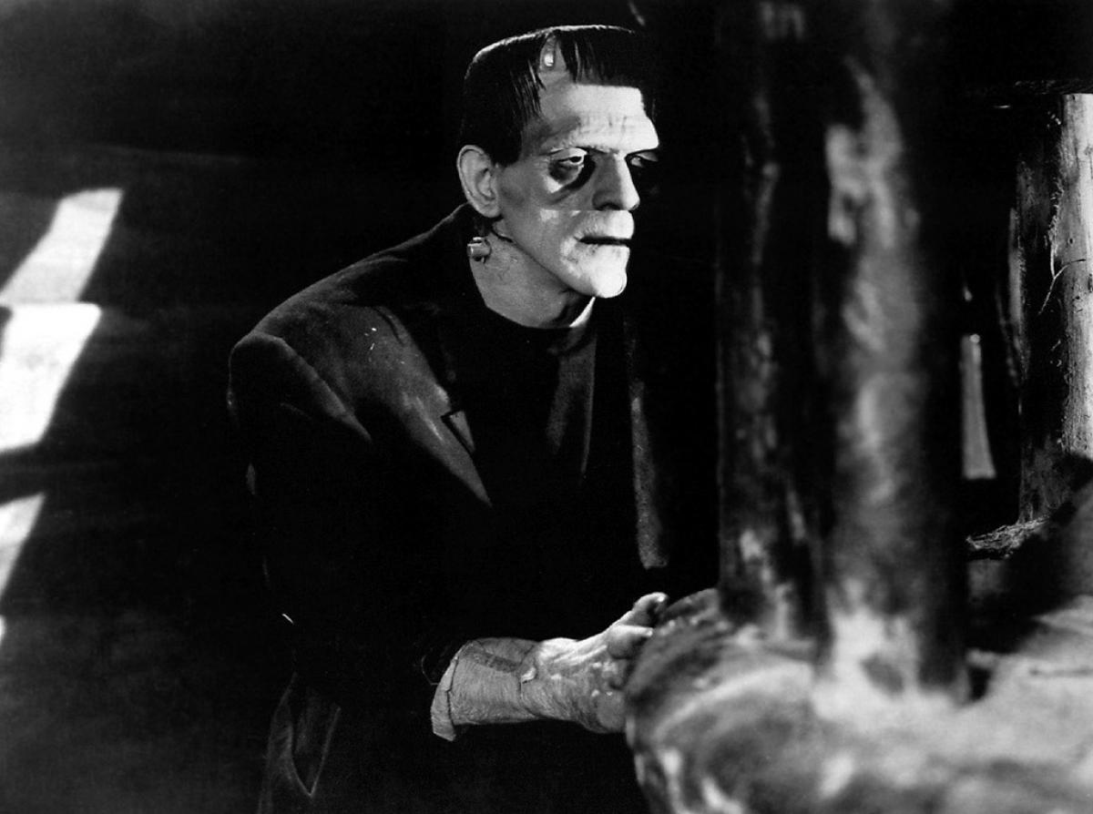 Actor Boris Karloff as Frankenstein, peaking around a corner