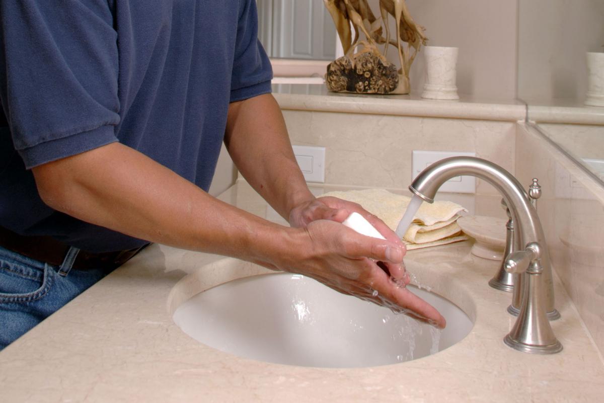 A man washing his hands.