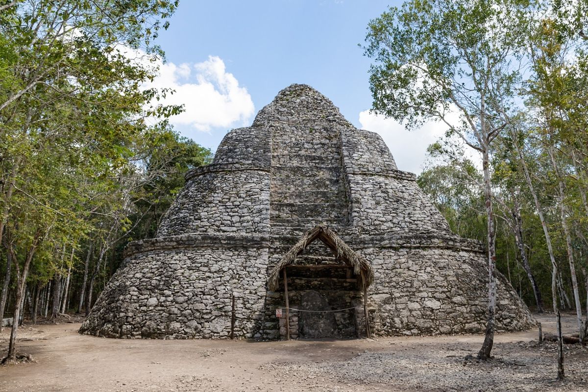 An ancient Mayan structure with surrounding jungle