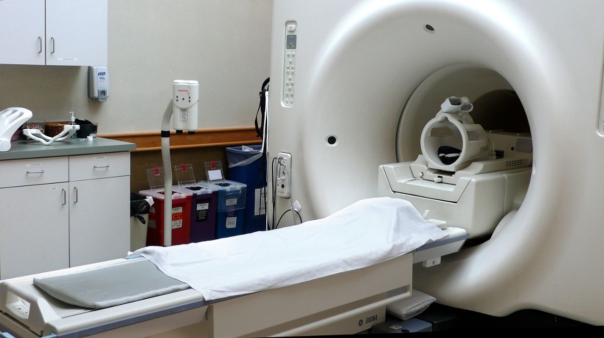 An MRI scanner in a hospital room, sitting empty