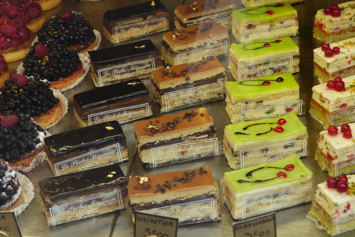 Various neat pastries stand displayed in rows