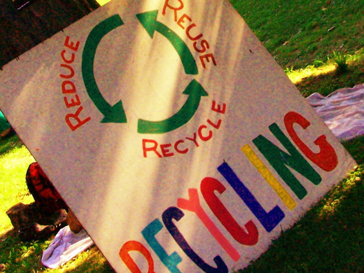 A colorful sign with "Reduce, Reuse, Recycle" written on it